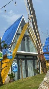 a house with a blue roof with a slide at Nhu's Cozy Home in Phước Thuận (1)