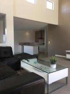 a living room with a couch and a coffee table at Azure in Bridport