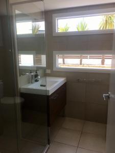 a bathroom with a sink and a mirror at Azure in Bridport