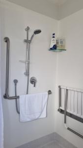 a bathroom with a shower with a towel at Lodges On Pearson Unit 1 in Cromwell