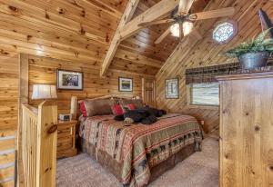 a bedroom with a bed in a wooden cabin at Campfire Lodge in Sevierville +49 photos