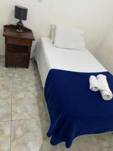 a bedroom with a bed with a blue blanket on it at Depto Ibarreta in Ibarreta