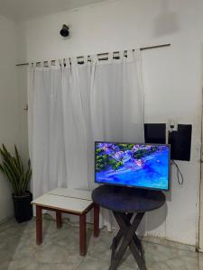 a computer monitor sitting on a stool next to a table at Depto Ibarreta in Ibarreta