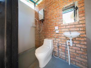 a bathroom with a white toilet and a sink at Lù Yīng Retreats in Bukit Tinggi +52 photos