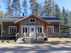 a house with solar panels on top of it at Riverside Cottage Äänekoski Sauna Hot Tub Northern Lights in Äänekoski