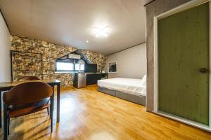 a bedroom with a bed and a table with a chair at Seorak HOT Spring Mammoth Resotel in Sokcho +196 photos