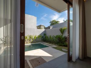 an external view of a villa with a swimming pool at Prawara Uluwatu in Uluwatu
