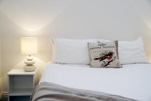 a bed with a book sitting on top of it at Historic Getaway in Launceston