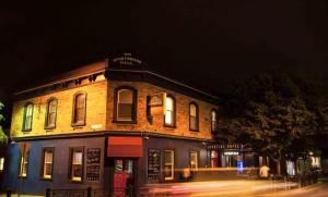 a building on the corner of a street at night at Historic Getaway in Launceston