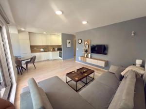 a living room with a couch and a table at Lira Bay in Igalo