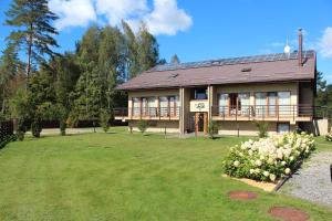 a house with a large yard in front of it at Vila Ula in Perloja