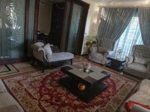 a living room with a couch and a coffee table at 430 Capital Suites in Islamabad