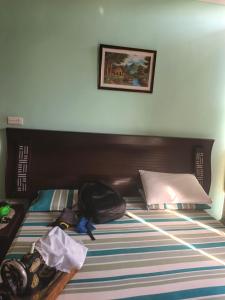 a bedroom with a bed with a backpack on it at 430 Capital Suites in Islamabad