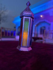 a colorful glass lantern sitting on top of a table at Sariska Haveli in Alwar +13 photos