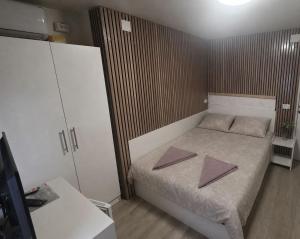 a small bedroom with a bed with two mats on it at Casa de Cultura house in Constanţa