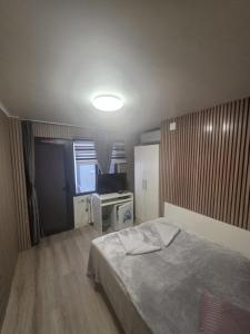 a small bedroom with a bed and a window at Casa de Cultura house in Constanţa +6 photos