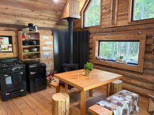 eine Küche mit Holztisch und Herd in der Unterkunft Mini Moo-light Cabin in Clearwater