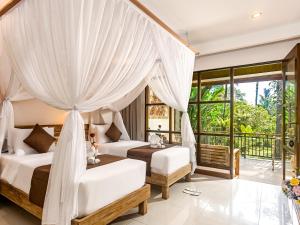 a bedroom with two beds and a balcony at Alas Petulu Villa Resort and Spa in Ubud +271 photos