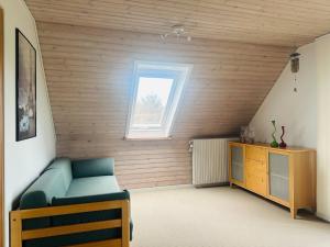 a room with a bed and a wooden wall at Family private house in Brovst