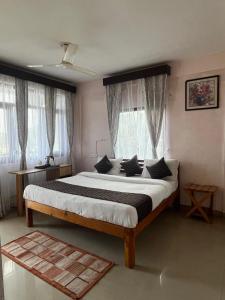 a bedroom with a large bed in front of a window at The himaliyan munros in Rānīkhet