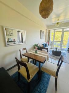 a living room with a table and chairs at Ocean Garden Villas Cluster B 3rd Floor Unit C in Boracay