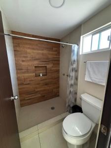 a bathroom with a toilet and a shower at Hotel Vistas Juventud in Chihuahua +5 photos