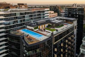 an aerial view of a building with a swimming pool at Tyrian Albert Park Lake in Melbourne
