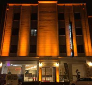 a building with a sign on the front of it at night at Safa Royal Museum Hotel in Konya