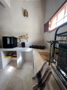 a kitchen with a table in a room at Bahari Studio by Bora Pamoja Homes Pool, Solar Backup & 5 Min to Beach in Jambiani