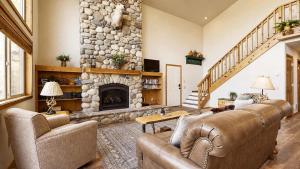 a living room with two couches and a stone fireplace at Spacious McCall Home Near Golf Course in McCall