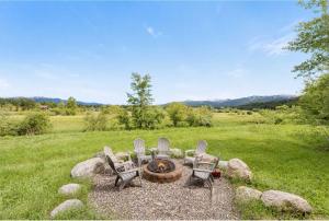 a group of chairs sitting around a fire pit at Spacious McCall Home Near Golf Course in McCall
