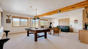 a living room with a ping pong table in it at Spacious McCall Home Near Golf Course in McCall