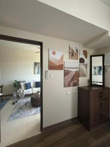 a living room with a couch and a mirror at Ocean Garden Villas Cluster B 3rd Floor Unit C in Boracay