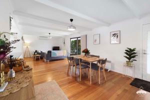 a dining room and living room with a table and chairs at Between Waters Stay 3 Pay 2 Winter Special in Yanakie