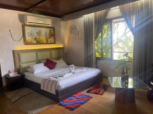 a bedroom with a bed and a glass table at Sampan Cafe and Resort in Cox's Bazar