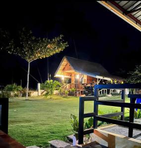 a house at night with the lights on at CocoVille Guesthouse KUBO in Alegria