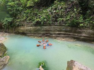 a group of people in a boat in a cave at CocoVille Guesthouse KUBO in Alegria +2 photos