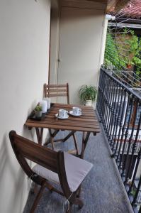 a wooden table and chair on a balcony at Alle Volte Torino in Turin