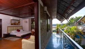 a bedroom with a bed and a balcony at Sampan Cafe and Resort in Cox's Bazar
