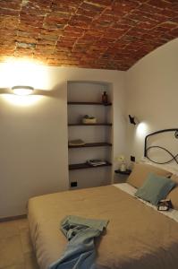 a bedroom with a bed with a brick ceiling at Alle Volte Torino in Turin