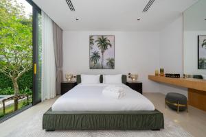 a bedroom with a white bed and a large window at Botanica Foresta 4BDR by Villacarte in Ban Phru Champa +69 photos