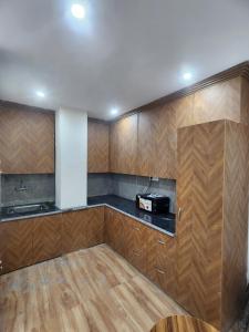 a kitchen with wooden cabinets and a counter top at Hazy hill in Mussoorie