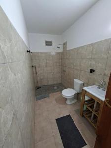 a bathroom with a toilet and a sink at Flor de la Montaña 2 in Fiambalá