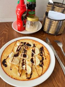 a pizza on a white plate on a table at Hue Sweethouse 2 Homestay in Hue +34 photos