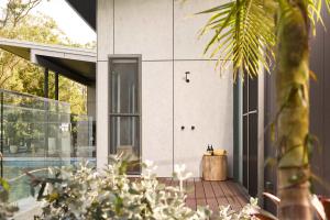 a house with a glass door and a courtyard at The Pavilion Wamberal in Wamberal