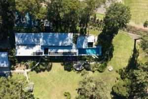 an aerial view of a house with a swimming pool at The Pavilion Wamberal in Wamberal