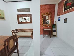a room with a table and a mirror at Ghanaya Guesthouse in Ngaglik
