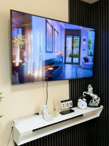 a flat screen tv hanging on a wall at AnR Condo at Avida Towers in Cagayan de Oro