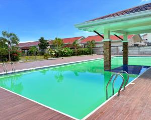 a swimming pool at a resort with a pavilion at Casa Tranquila Panglao in Dauis