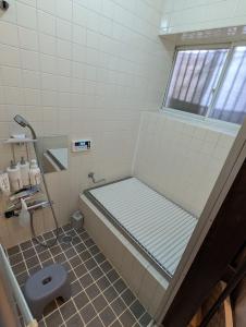 a bathroom with a shower and a toilet in it at アトイエ-Atoie- in Odawara